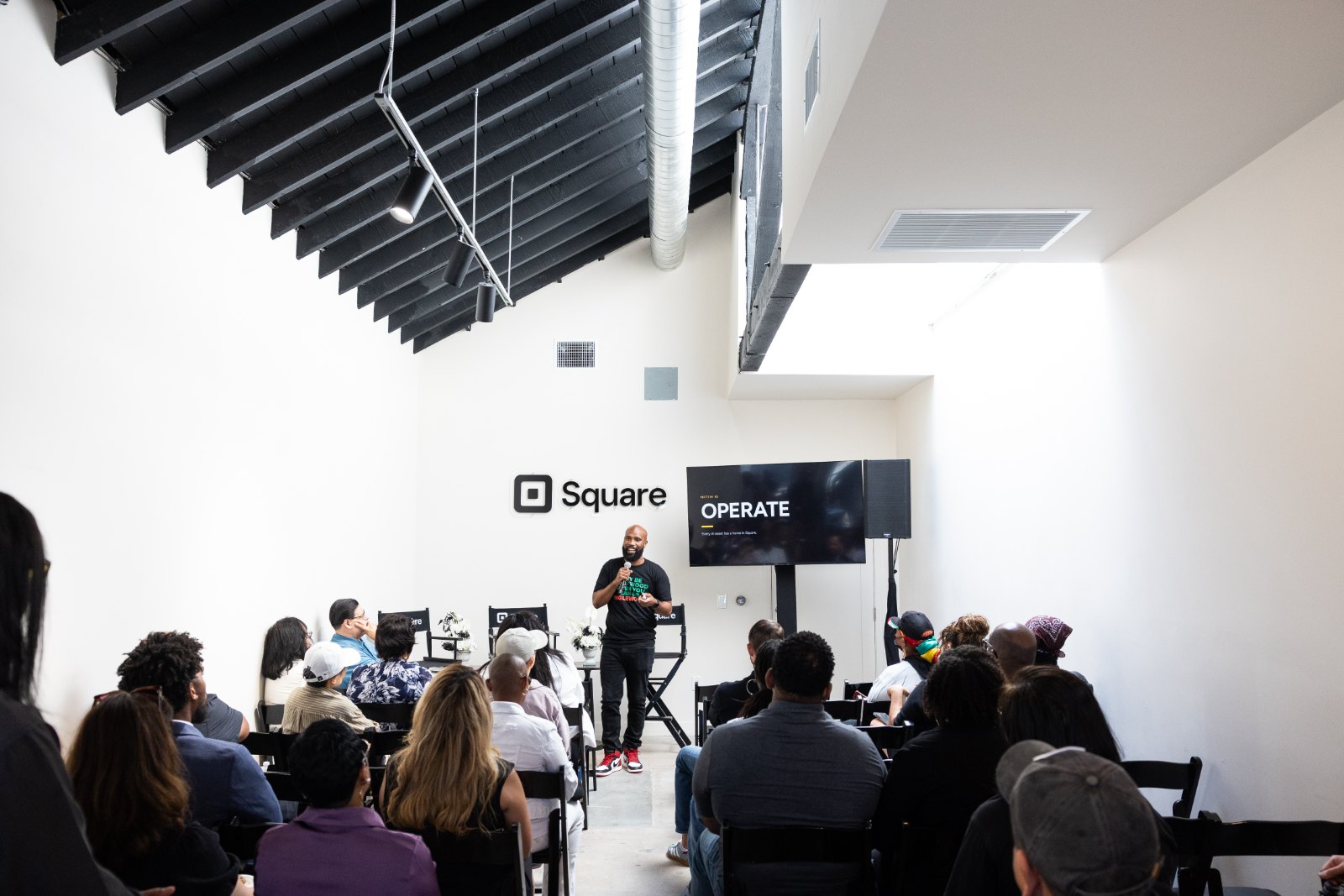 Terell Johnson speaking to a room of owners at Square LA in front of a slide reading Operate